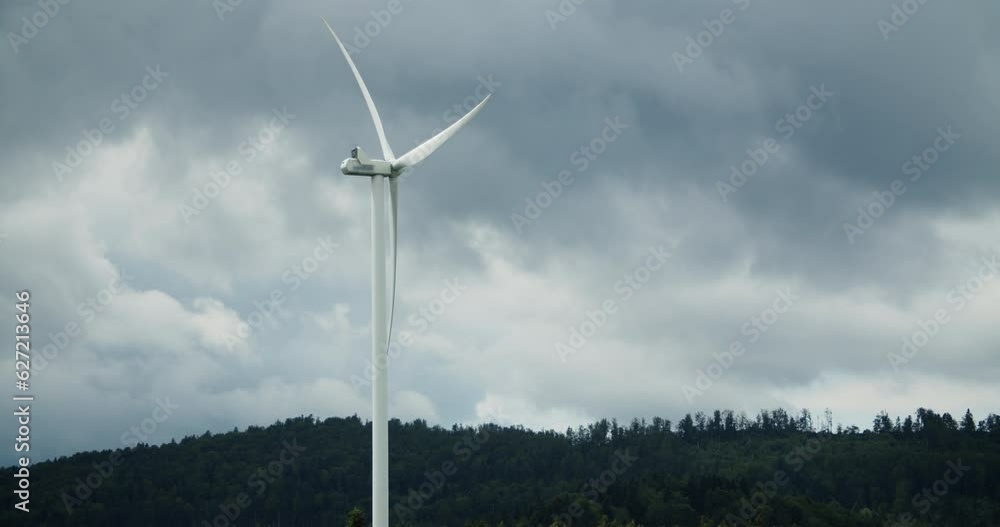 Wind turbine turning at forest Wind turbine turning at forest