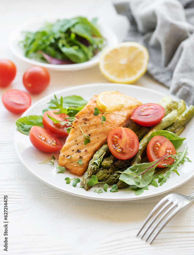 Baked Delicious salmon, green asparagus on plate Baked Delicious salmon, green asparagus on plate