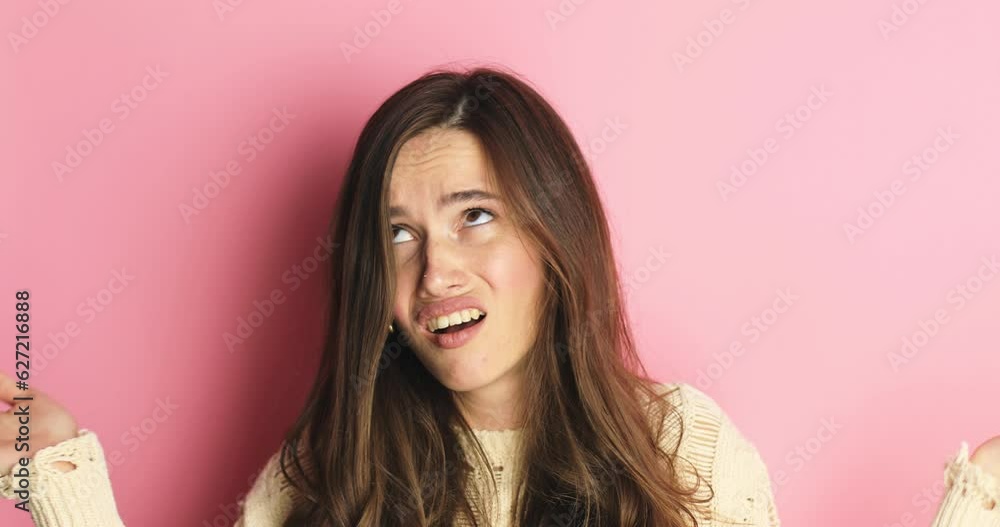 WHY! HOW! Angry frustrated brunette woman upset raising hands in indignant expression with suffer face feeling confuse don't understand asking for reasons what's wrong gesture on pink background. WHY! HOW! Angry frustrated brunette woman upset raising hands in indignant expression with suffer face feeling confuse don't understand asking for reasons what's wrong gesture on pink background.