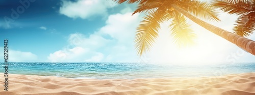Summer background, nature of tropical beach with rays of sun light. Golden sand beach, palm tree, sea water against blue sky with white clouds. Copy space, summer vacation concept
