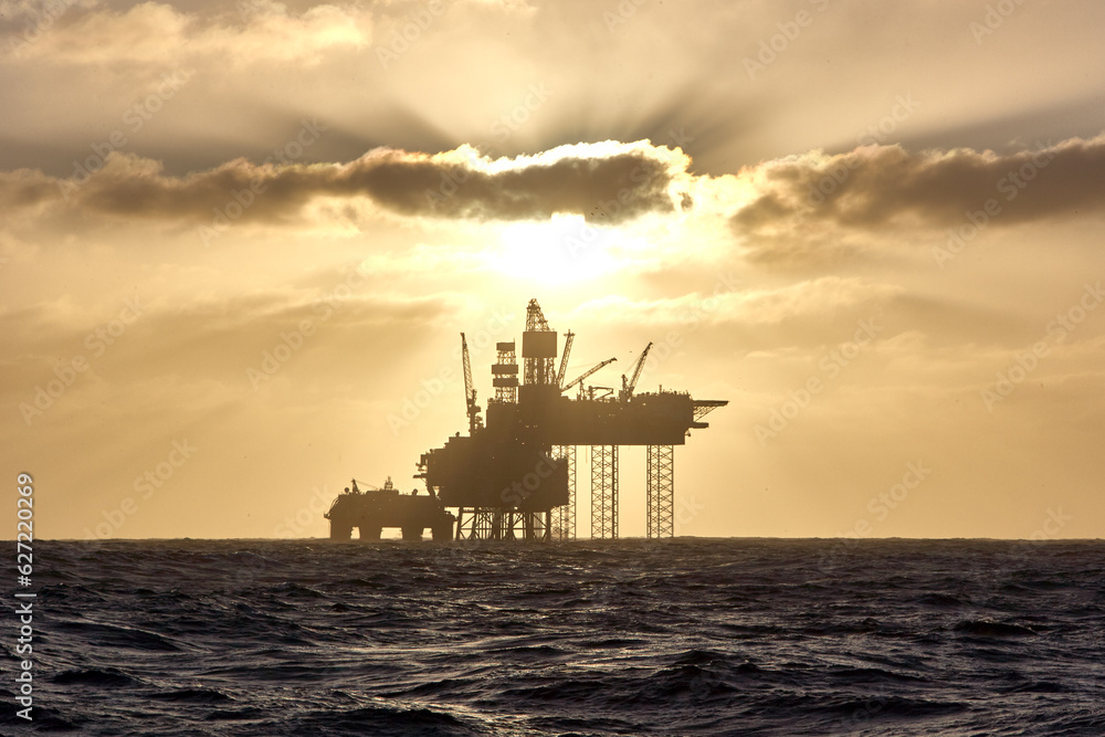 Silhouette of a jack up drilling rig in the North Sea at sunset. North sea offshore platform for oil and gas.
