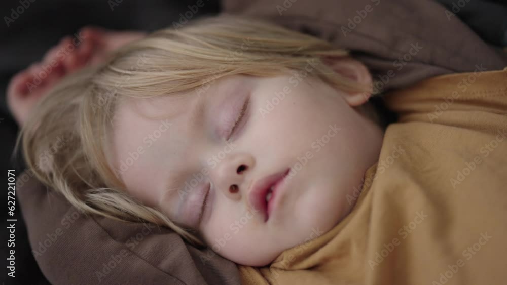 Capture the serenity of a 3-year-old Caucasian boy, in a close-up shot, sleeping peacefully on a comfortable black leather couch. A heartwarming scene of innocence and tranquility Capture the serenity of a 3-year-old Caucasian boy, in a close-up shot, sleeping peacefully on a comfortable black leather couch. A heartwarming scene of innocence and tranquility