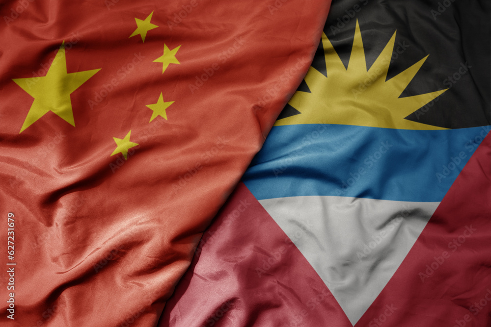 big waving national colorful flag of china and national flag of antigua and barbuda . big waving national colorful flag of china and national flag of antigua and barbuda .