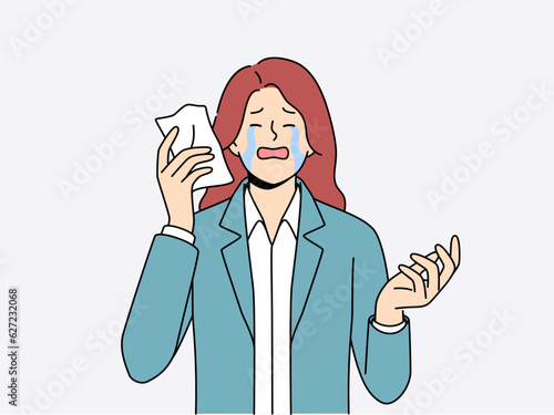 Upset woman crying wiping tears with paper napkin after business went bankrupt due to financial crisis. Sad businesswoman crying and needing support to solve psychological problems