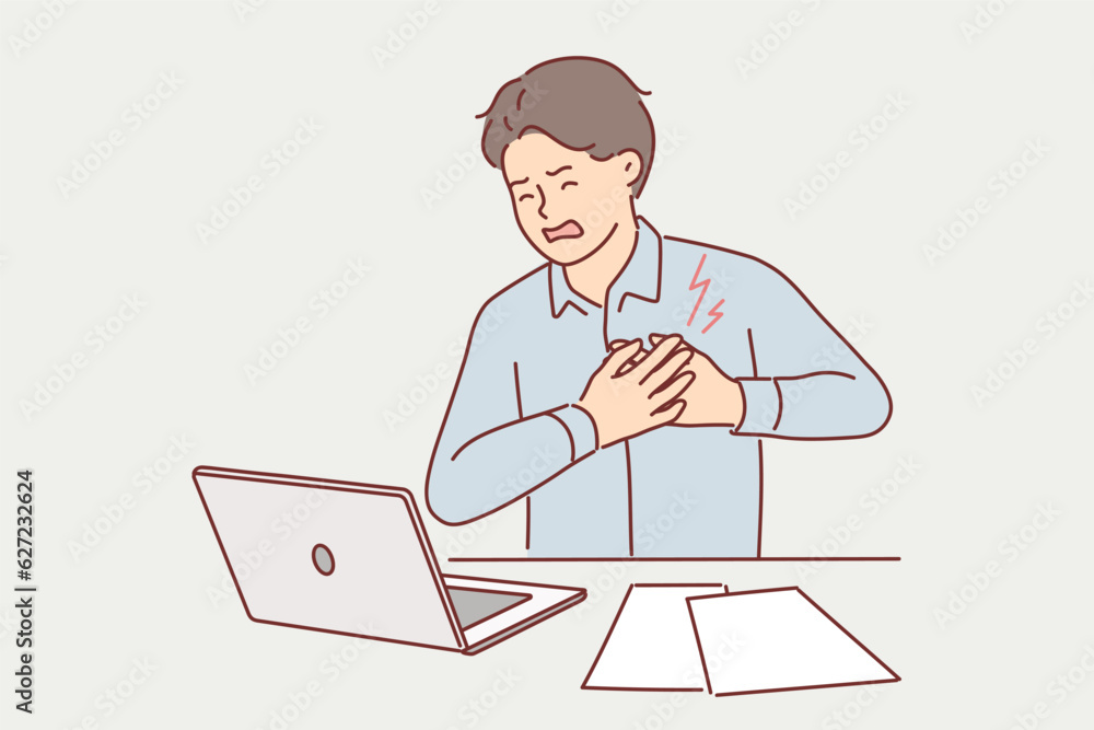 Businessman clutching heart feeling pain or infarct doing paperwork sitting at office desk Businessman clutching heart feeling pain or infarct doing paperwork sitting at office desk