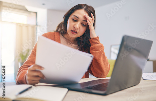 Documents, stress and woman on laptop in home with paperwork for online banking, finance and taxes. Remote work, worry and female person with computer for debt payment, financial report and bills photo