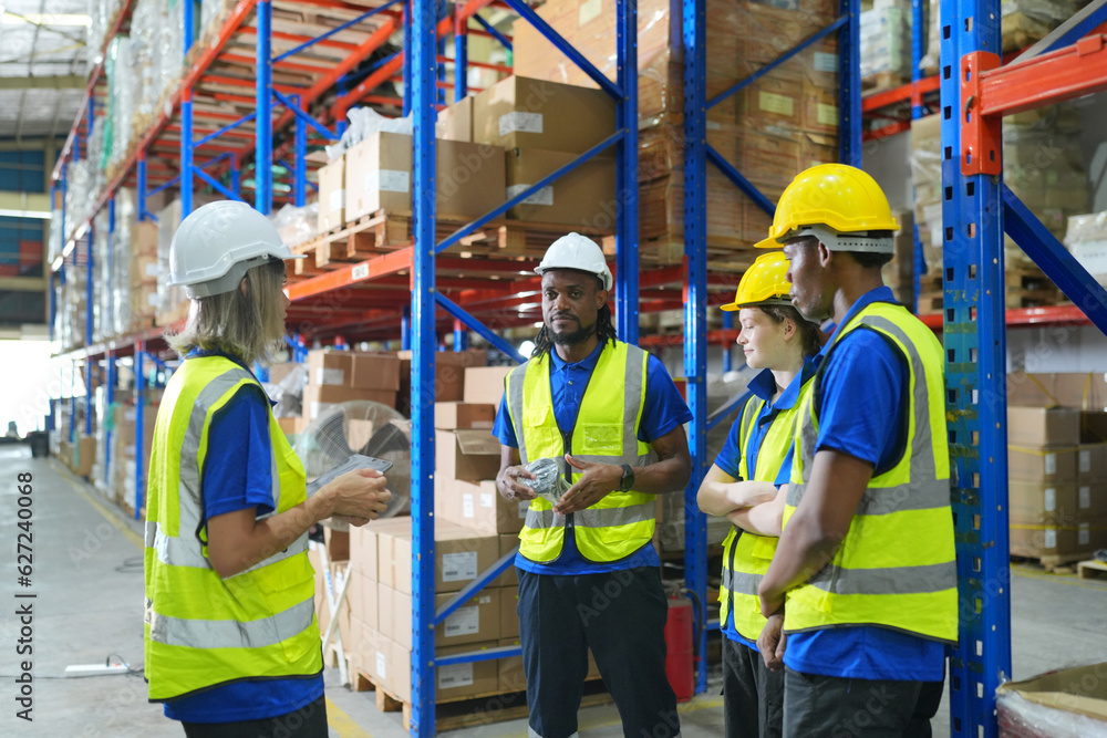 Worker working in large warehouse holding paper chart check list checking the material compare with the boxes wrapped with plastic keep on wooden pallet ready to ship to customer Worker working in large warehouse holding paper chart check list checking the material compare with the boxes wrapped with plastic keep on wooden pallet ready to ship to customer