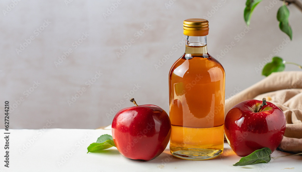 Healthy organic food. Apple cider vinegar in glass bottle and fresh red apples on a light background. Healthy organic food. Apple cider vinegar in glass bottle and fresh red apples on a light background.