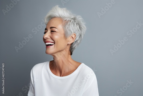 Beautiful gorgeous 50s mid age beautiful elderly senior model woman with grey hair laughing and smiling. Mature old lady close up portrait. Healthy face skin care beauty  skincare cosmetics  dental.