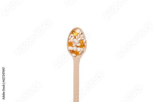 Vitamin capsules in a wooden spoon on a colored background. Pills served as a healthy meal. Drugs, pharmacy, medicine or medical healthycare concept photo