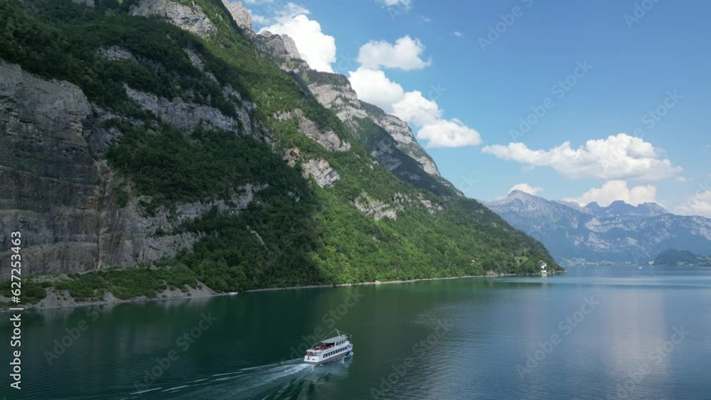 Tourists enjoying cruise in calm Walensee lake natural beauty,Switzerland Tourists enjoying cruise in calm Walensee lake natural beauty,Switzerland