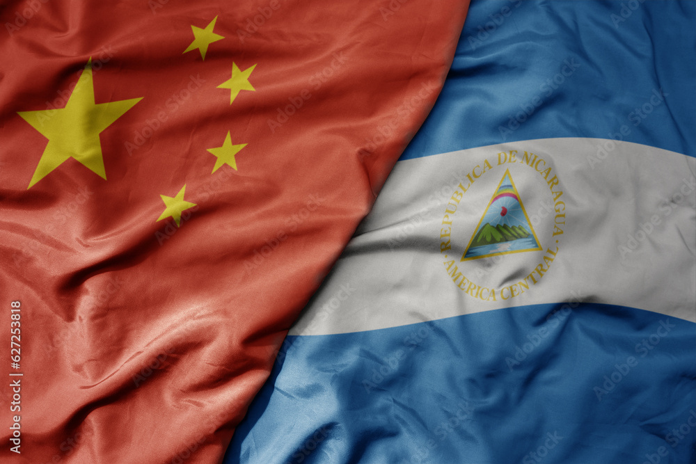 big waving national colorful flag of china and national flag of nicaragua . big waving national colorful flag of china and national flag of nicaragua .