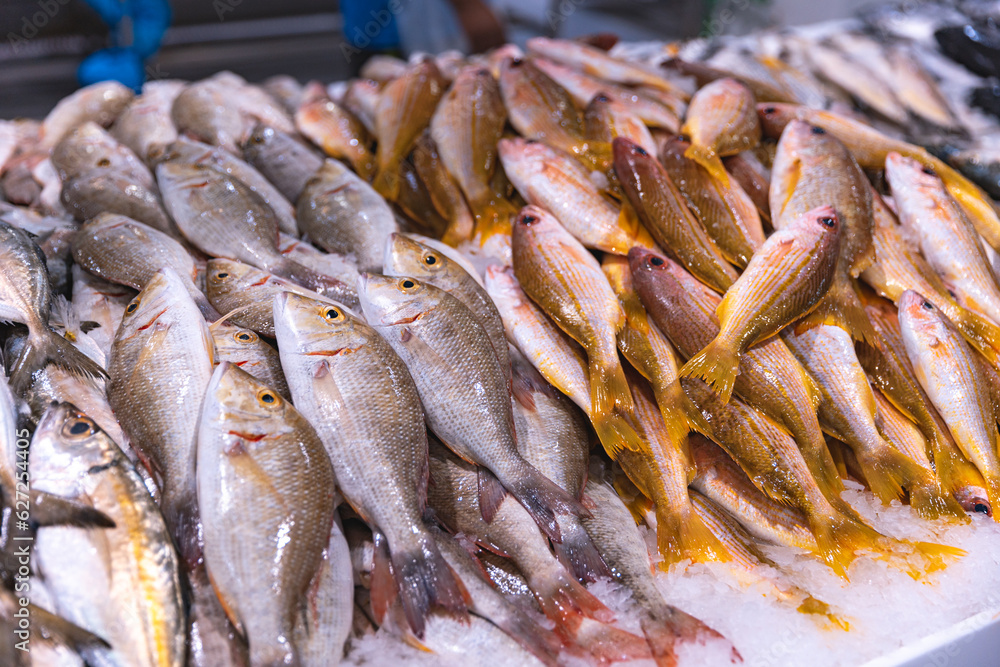 Emirates, Dubai, Deira waterfront fish market. Retailers offer fresh fish and crustaceans at their stalls on ice. Cod, sea bream, Shari fish, kingfish, , freshness, salmon, catch, prawn and shrimps.