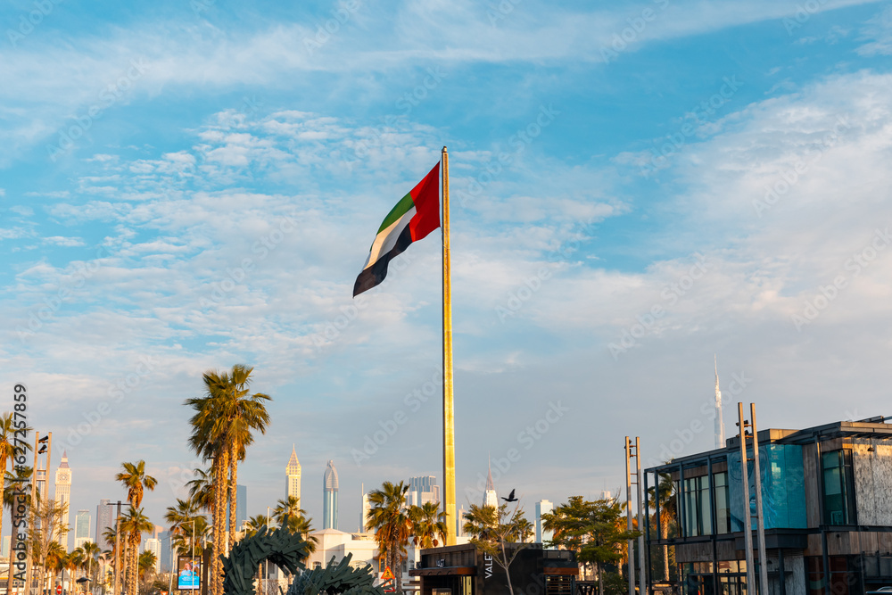 Dubai, United Arab Emirates - April 2023: La Mer Beach. National Flag of the emirates at the entrance of the area. Place with shops, restaurants, cafes at the Beach,  15 minutes far from Down Town.