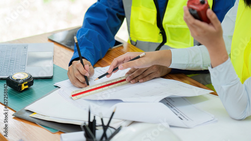 Closeup hands Civil engineers and architects discuss project construction together at the office