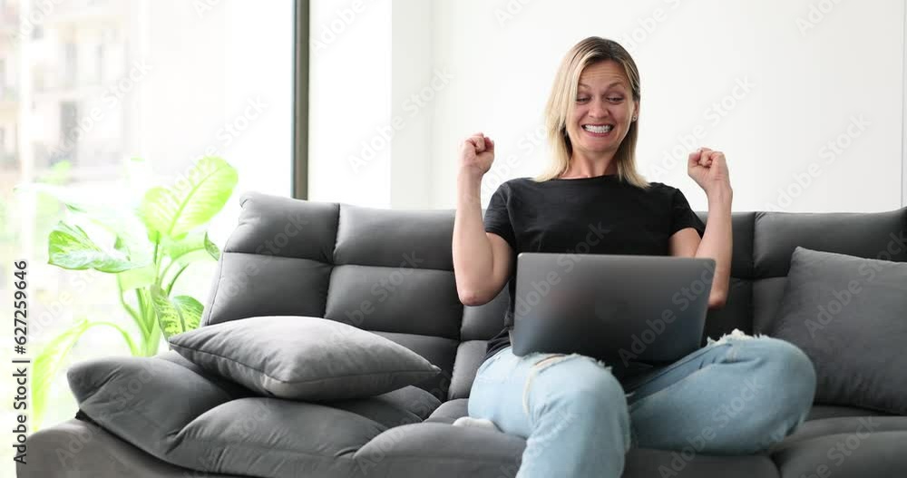 Delighted young woman looking at laptop screen, feeling euphoric about winning or success in online lottery. Excited woman triumphant reading pleasant good news Delighted young woman looking at laptop screen, feeling euphoric about winning or success in online lottery. Excited woman triumphant reading pleasant good news