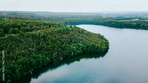 Aerial drone view of lake among forest, Nordrhein westfalen, Germany in summer day.