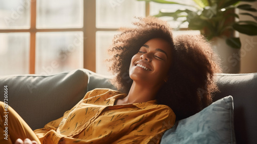 Happy Afro American woman relaxing on the sofa at home,Healthy life style, good vibes people and new home concept photo