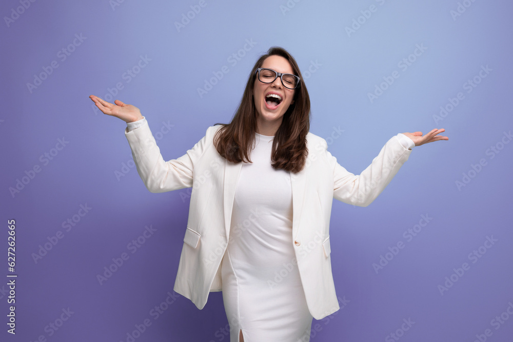 energetic young lady in a white dress and glasses demonstrates with her hands to the sides energetic young lady in a white dress and glasses demonstrates with her hands to the sides