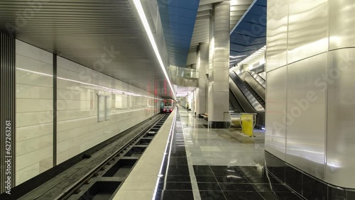 Interior of a modern subway station with trains timelapse hyperlapse. Moving back on a platform