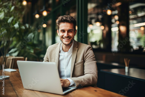 man working on laptop in cafe