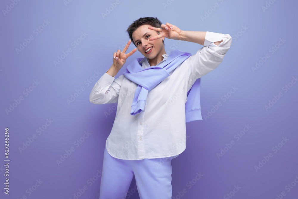 smiling young woman with short haircut in white shirt and blue pants smiling young woman with short haircut in white shirt and blue pants