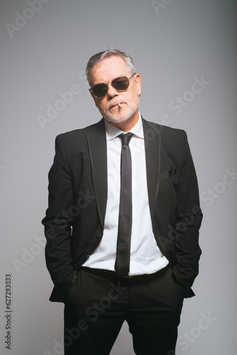 Confident businessman in suit standing in studio