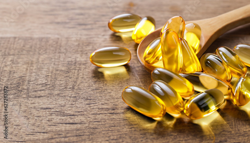 Fish oil capsules on wooden background, vitamin D supplement