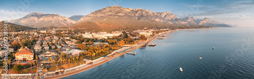 Experience the epitome of coastal beauty with breathtaking aerial panorama of Kemer, Turkey, showcasing luxurious hotels, a pristine sea beach, and majestic mountains in the backdrop. photo