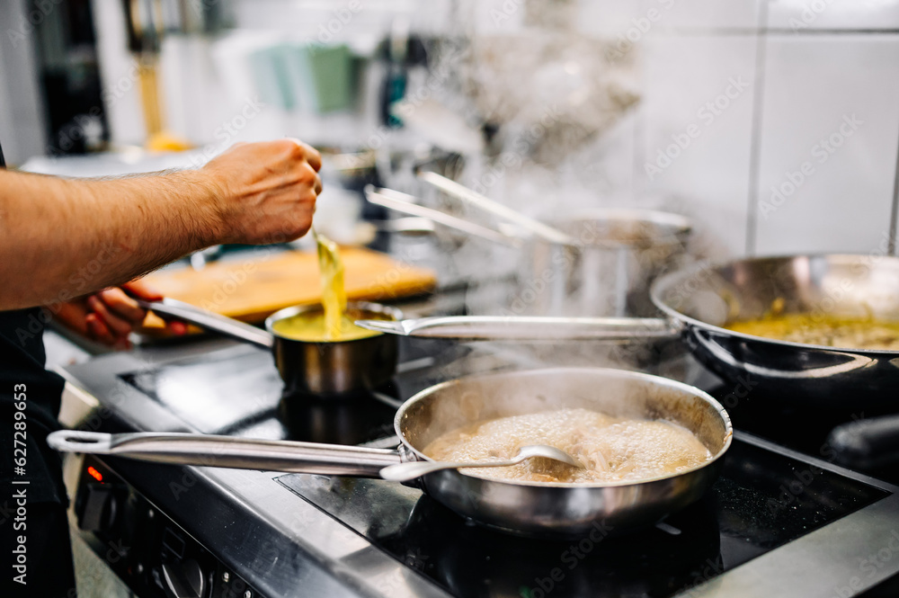 Chef cook hand cooking food at the restaurant kitchen Chef cook hand cooking food at the restaurant kitchen