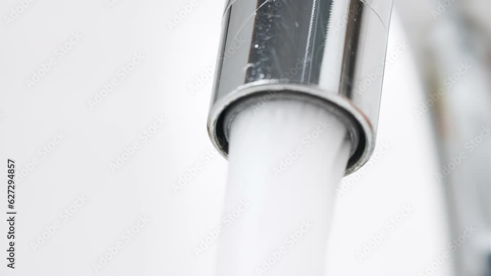 Water Flowing from the Tap in Bathroom. Macro Shot of Faucet. Turning On and Off Water for Using. Useful for Water Consumption, Ecological Problems and Drought Concept. Interior Real Time Prores 422. Water Flowing from the Tap in Bathroom. Macro Shot of Faucet. Turning On and Off Water for Using. Useful for Water Consumption, Ecological Problems and Drought Concept. Interior Real Time Prores 422.