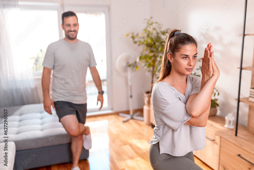 Couple doing morning yoga session together at home Couple doing morning yoga session together at home