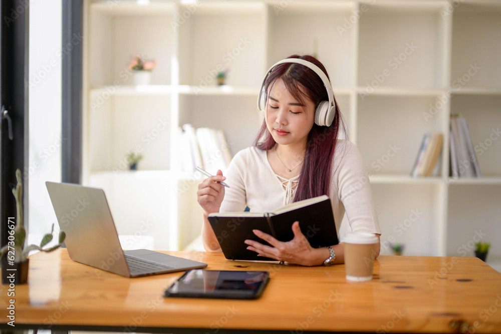 University girl student studying online lesson at public workspace, Remote online video for educational learning, Research information from the video. University girl student studying online lesson at public workspace, Remote online video for educational learning, Research information from the video.