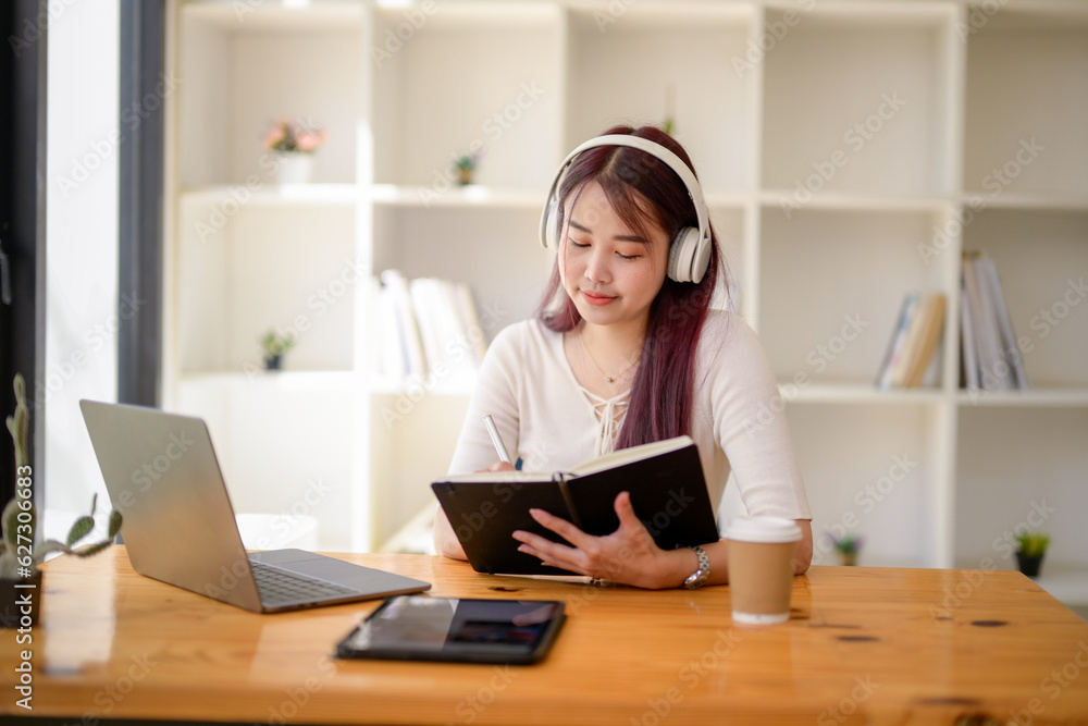 University girl student studying online lesson at public workspace, Remote online video for educational learning, Research information from the video. University girl student studying online lesson at public workspace, Remote online video for educational learning, Research information from the video.