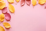 Autumn background with few surrealistic leaves. Empty space in the middle. Pastel pink and yellow