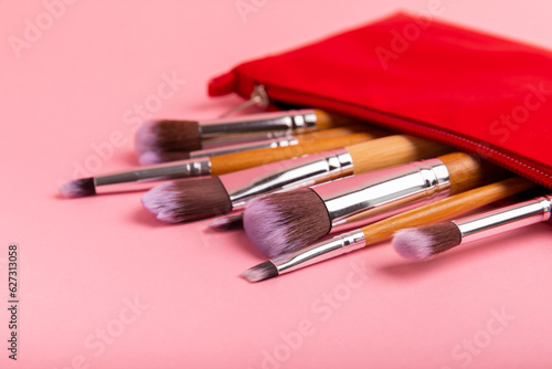 Cosmetic makeup brush on a pink background. Cosmetic product for make-up. Creative and beauty fashion concept. Fashion. Collection of cosmetic makeup brushes, top view, banner.Place for text. MOCAP.