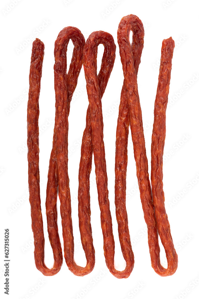 Thin smoked kabanosy sausage on a white background. Thin smoked kabanosy sausage on a white background.