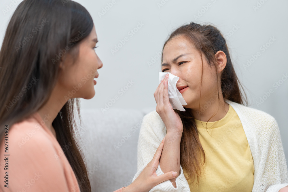 Two women talking about problems at home. Asian women embrace to calm their sad best friends from feeling down. Female friends supporting each other. Problems, friendship, and care concept Two women talking about problems at home. Asian women embrace to calm their sad best friends from feeling down. Female friends supporting each other. Problems, friendship, and care concept