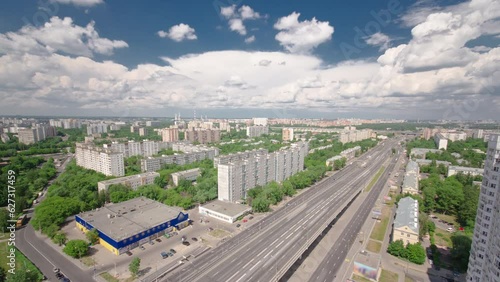 Top view from above of traffic on the elevated avenue road aerial timelapse overpass on Yaroslavl highway in Moscow, Russia. Panorama with many houses and green trees photo