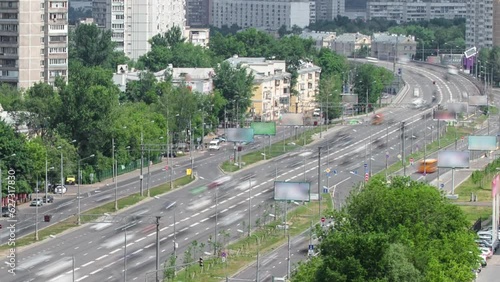 Top view from above of traffic on the elevated avenue road aerial timelapse overpass on Yaroslavl highway in Moscow, Russia. Green trees along the street photo