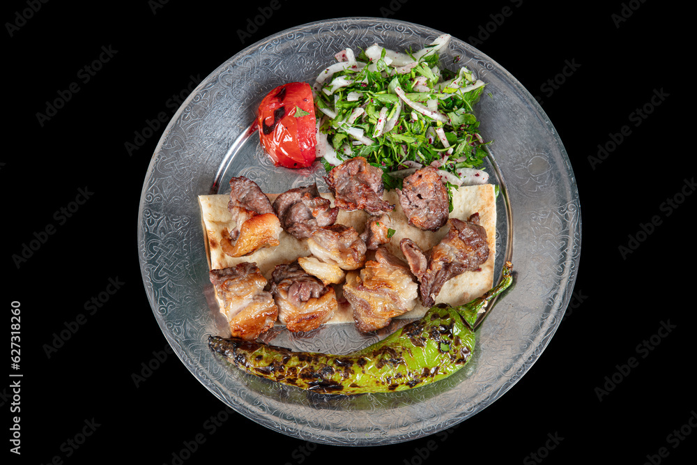 Turkish cuisine Meat skewers. Barbecue skewers with juicy meat on metal plate. Shish kebab barbecue meat with onions and tomatoes. Turkish cuisine Meat skewers. Barbecue skewers with juicy meat on metal plate. Shish kebab barbecue meat with onions and tomatoes.