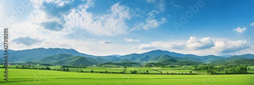 Panoramic natural landscape with a green grass field, blue sky with clouds, and mountains in the background. Panorama summer spring meadow. Generative AI.