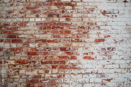 Old, but solid brick wall with whitewash and wear
