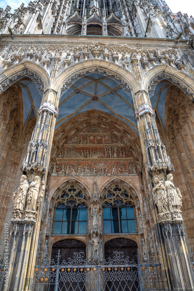 Ornate facade of famous medieval architecture, detail. The main gate of Ulm Cathedral