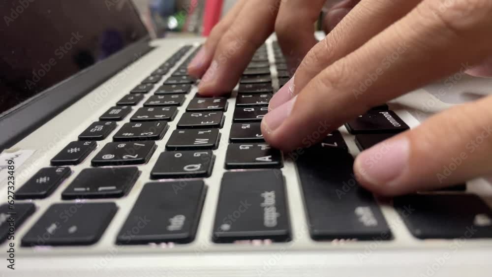 Close up male hands typing on laptop Thai keyboard black buttons Close up male hands typing on laptop Thai keyboard black buttons