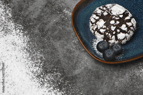 Chocolate crinkle cookies with blueberries and powdered sugar