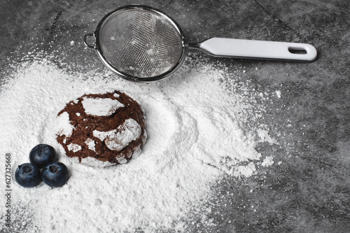 Chocolate crinkle cookies with blueberries and powdered sugar