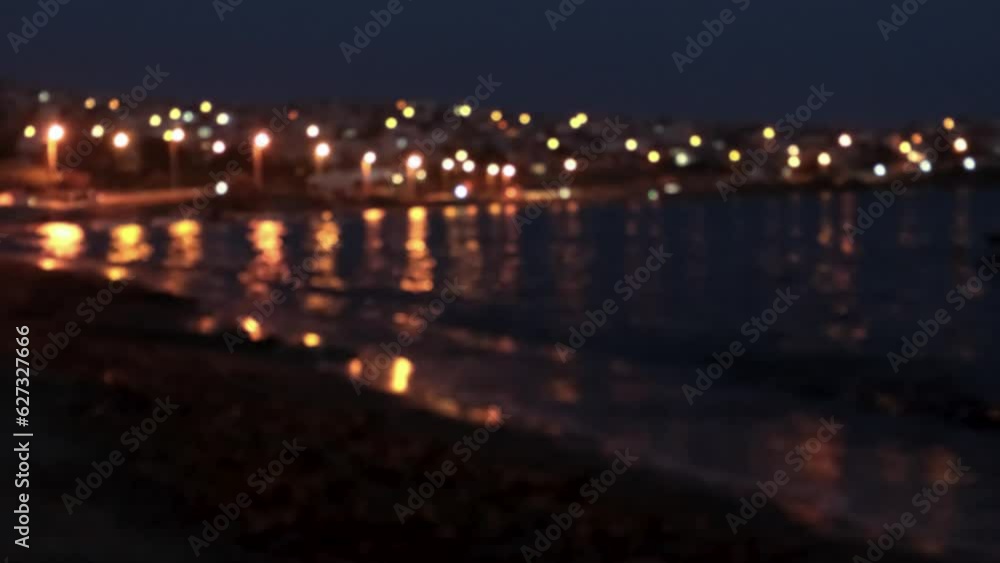 Out of focus coastal city in night time Out of focus coastal city in night time