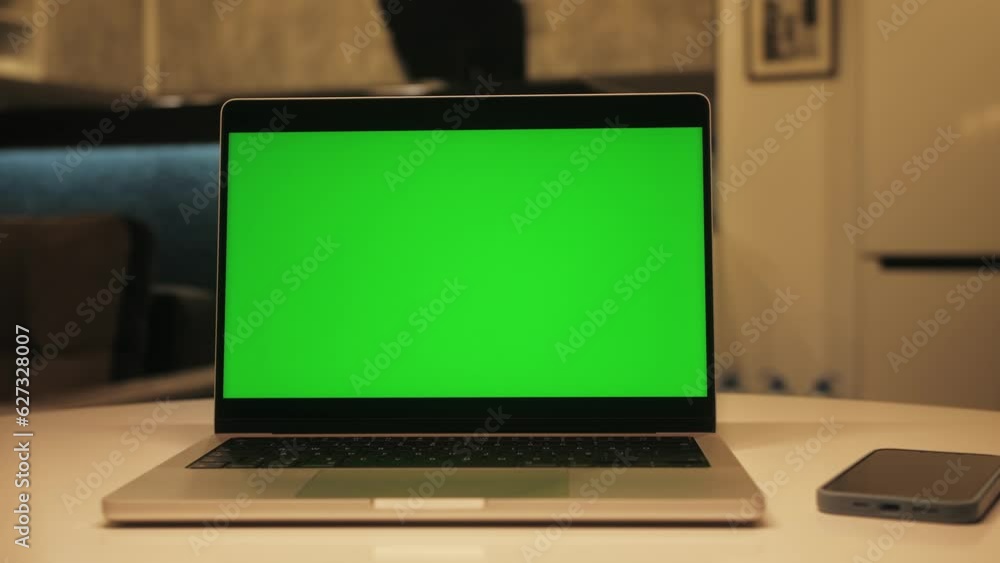 Close up of modern chroma key green screen laptop set up for work on desk at night, concept of remote work, technology concept. Close up of modern chroma key green screen laptop set up for work on desk at night, concept of remote work, technology concept.