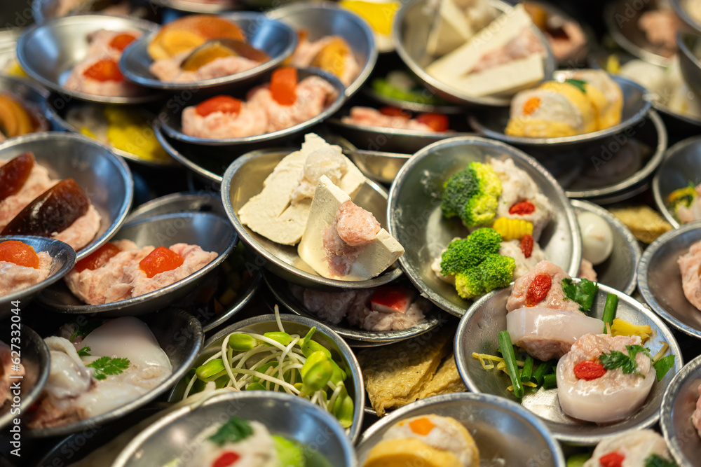 Various type of Dim sum, famous chinese appertizer food which are prepared in stainless plate. Raw food menu object photo, close-up and selective at top.